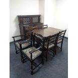 An eight piece dining room suite comprising of buffet back sideboard,