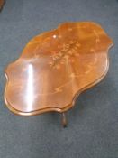 A shaped Italianate pedestal coffee table