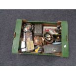 A box containing a collection of vintage tins.