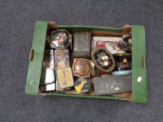 A box containing a collection of vintage tins.