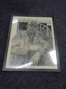 A framed monochrome print of Ronnie Campbell MP working as a miner.