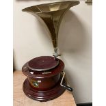 A reproduction HMV tabletop gramophone with brass horn.