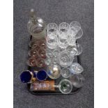 A tray containing assorted glassware to include an antique etched glass beaker,