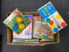 A box containing vintage board games by Merit, Waddingtons etc.