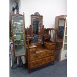 An Edwardian walnut sunk centre dressing chest with triple mirror