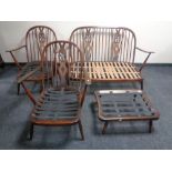 A four piece Ercol elm and beech lounge suite in an antique finish comprising of two seater settee,