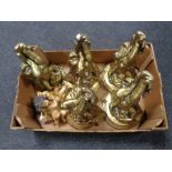 A box containing five gilt cherub wall shelves together with two further cherub figures.