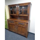 A 20th century oak double door sideboard fitted two drawers with cupboards above