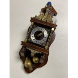 A continental wall clock with brass pear weights