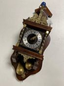 A continental wall clock with brass pear weights