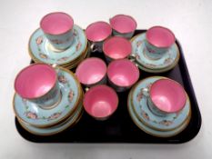A tray containing 32 pieces of antique gilt rimmed rose patterned tea china.