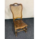 An early 20th century beech bergere rocking chair