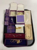 A tray containing boxed silver and costume jewellery to include necklaces, earrings etc.