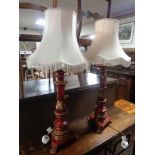 A pair of painted wooden table lamps on paw feet with tasselled shades