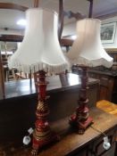 A pair of painted wooden table lamps on paw feet with tasselled shades