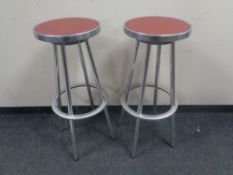 Three circular aluminium bar stools.
