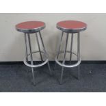 Three circular aluminium bar stools.