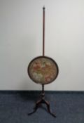 A 19th century mahogany tapestry pole screen.