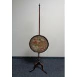 A 19th century mahogany tapestry pole screen.