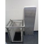 A stainless steel commercial tray stand together with a stainless steel shelf.