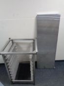 A stainless steel commercial tray stand together with a stainless steel shelf.