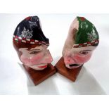 An unusual pair of hand painted shells mounted on wooden plinths, height 15 cm.