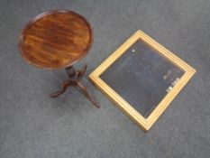 A tabletop display case together with a mahogany wine table.