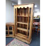 A set of sheesham wood bookshelves fitted drawer beneath