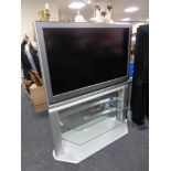 A Toshiba 37'' LCD TV with remote, on stand.