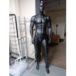 A male shop mannequin on stand (black).