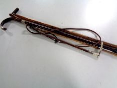 A bundle of four antique walking sticks and canes,