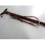 A bundle of four antique walking sticks and canes,