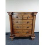 A Victorian mahogany bowfronted five drawer chest with pillar column supports