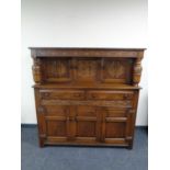 An Edwardian carved oak court cupboard