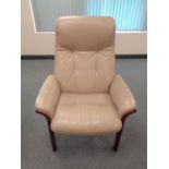 A late 20th century beige leather high backed armchair.
