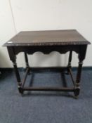 A nineteenth century carved oak occasional table