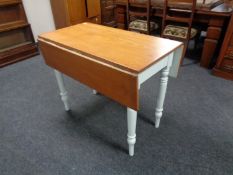 An antique pine drop leaf kitchen table on painted legs