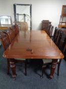 A 19th century mahogany wind out dining table with two leaves on castors