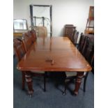 A 19th century mahogany wind out dining table with two leaves on castors