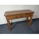 A sheesham wood side table, fitted two drawers.