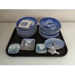 A tray of sixteen Royal Copenhagen Christmas plates, shallow dishes,