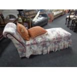 A storage chaise longue upholstered in a floral fabric