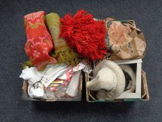 Two boxes containing woolen rugs, table linens, curtains, fur hat etc.