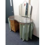 A mid century kidney shaped dressing table with triple mirror