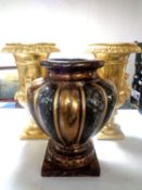 A pair of contemporary gilt composite urns together with a vase