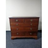 A 19th century five drawer chest with circular brass drop handles on bracket feet.