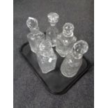 A tray containing five cut glass lead crystal decanters.