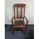 An Edwardian Arts and Crafts armchair.