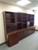 A twin section 20th century bookcase, fitted cupboards below, in a mahogany finish (as found).