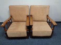 A pair of Edwardian oak adjustable armchairs